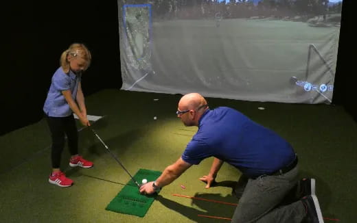 a man and a woman playing golf