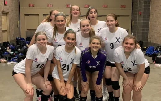 a group of girls in athletic uniforms