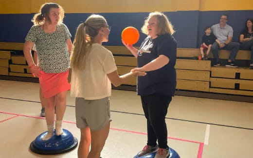 a group of women playing with a frisbee