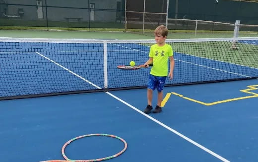 a boy playing tennis
