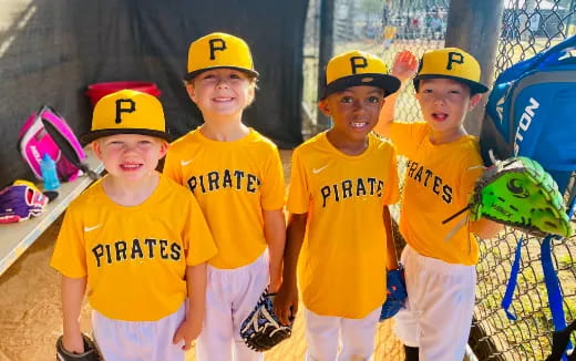 a group of kids wearing baseball uniforms