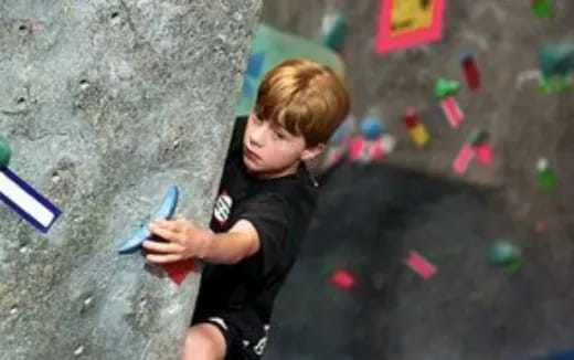 a boy climbing a rock