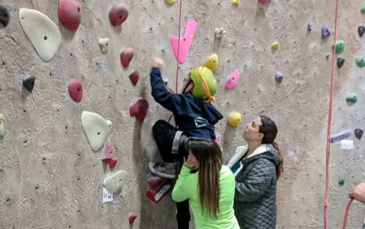 a group of people climbing a rock wall