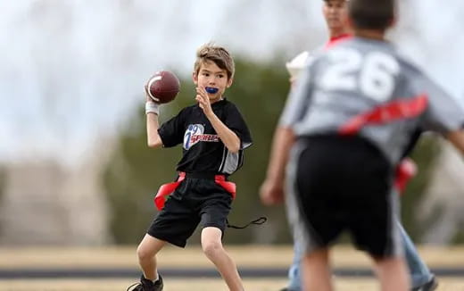 a boy throwing a ball