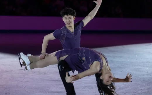 a man and woman ice skating