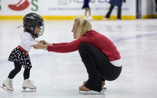 a woman and a child on ice