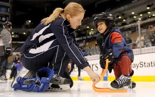 a person and a child on an ice rink