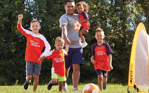 a group of kids playing football