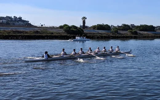 a group of people rowing a boat