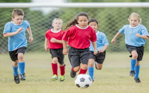 a group of kids playing football