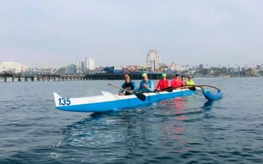 a group of people rowing a boat