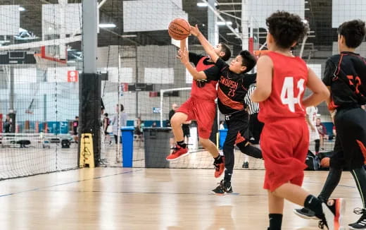 a group of people playing basketball