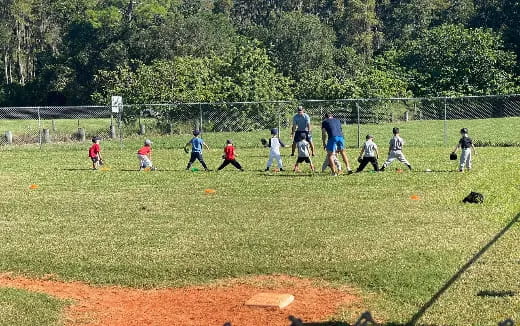 a group of kids playing baseball