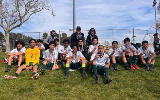 a group of people sitting on the grass
