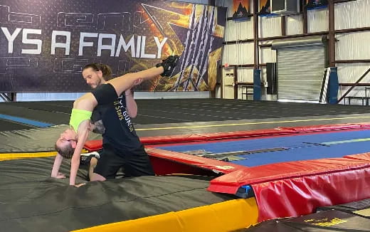 a person doing a handstand on a mat