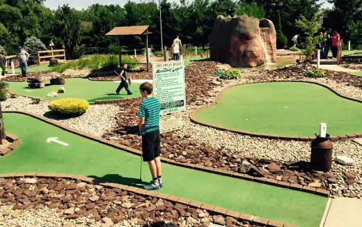 a boy standing in a park