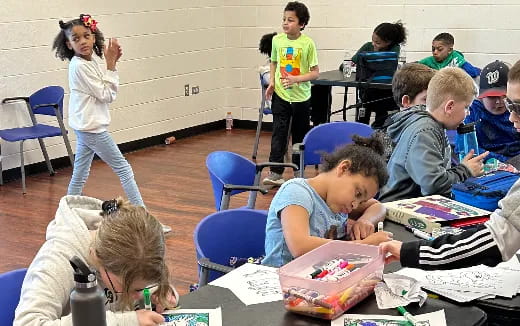 a group of children sitting in a classroom