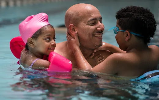 a person and a child in a pool