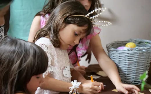 a group of children writing on paper