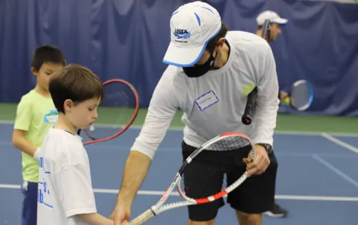 a man and a boy playing tennis