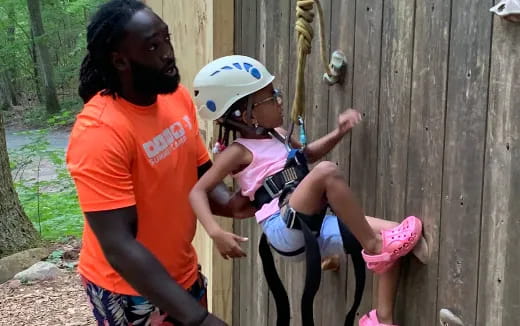 a person and a child playing with a toy