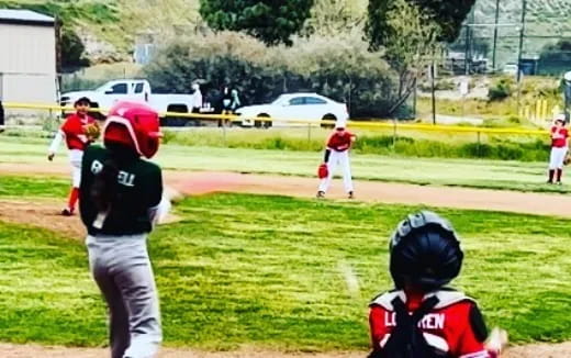 a group of kids playing baseball