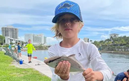 a girl holding a fish