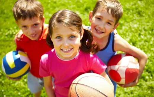 a group of kids playing with balls
