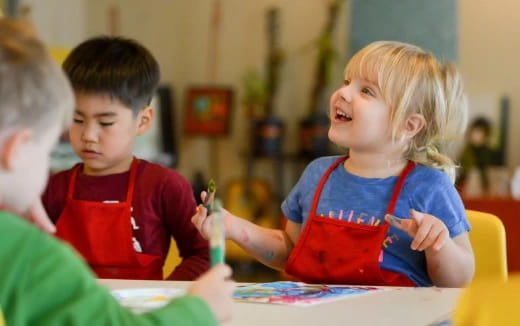 a few children sitting at a table