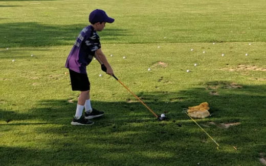 a boy playing tee ball