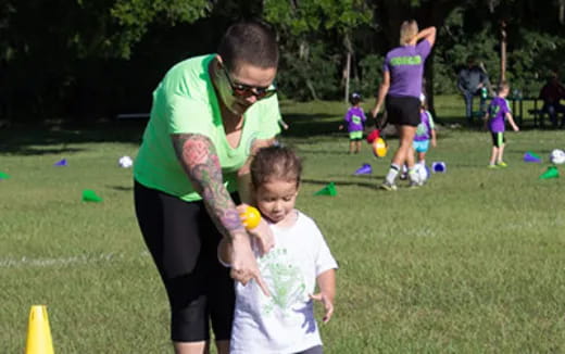 a person and a boy playing football