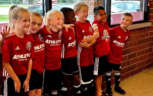 a group of kids in red uniforms