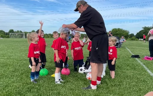 a person with kids playing football