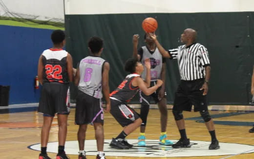 a group of people playing basketball