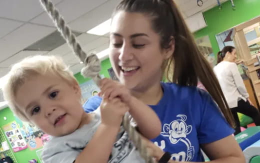 a person brushing a baby's teeth
