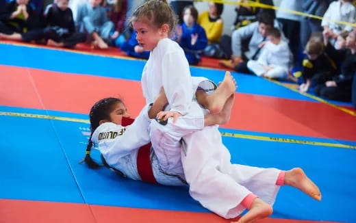 a couple of boys in karate uniforms