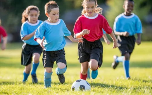 kids playing football on a field