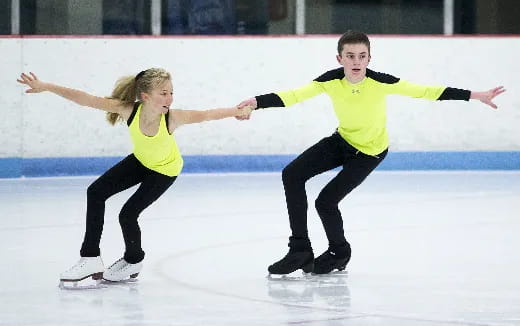 a man and a woman ice skating