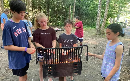 a group of children playing a piano
