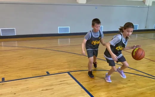 a couple of kids playing basketball