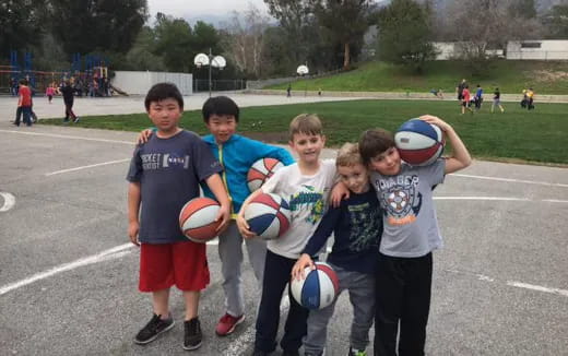 a group of kids holding balls