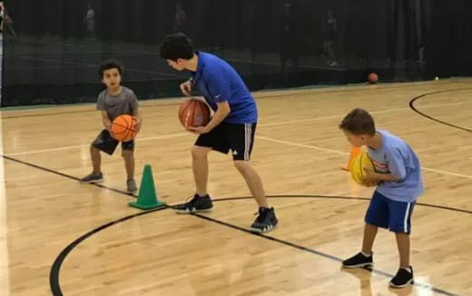 a group of boys playing basketball