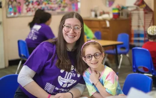 a person and a child sitting at a table