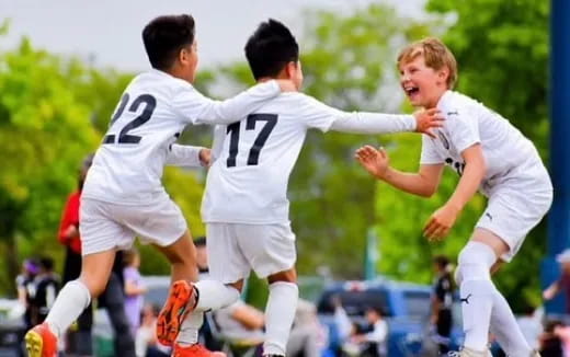a group of men in white uniforms running