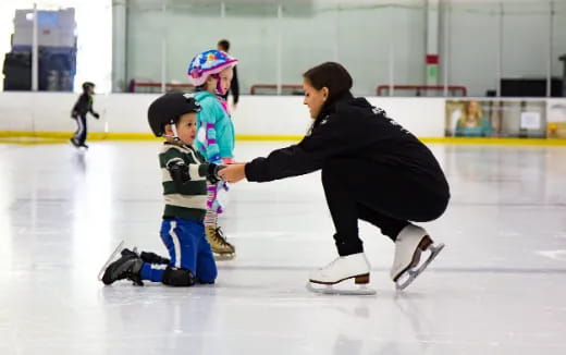 a person and a child on an ice rink