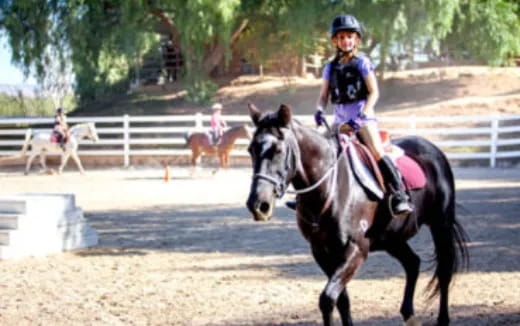 a girl riding a horse