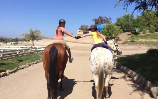 two women riding horses