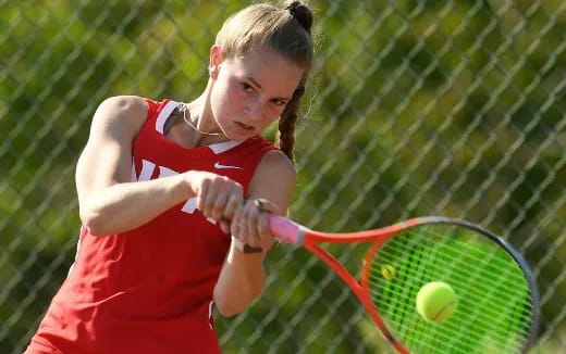 a person hitting a ball with a tennis racket
