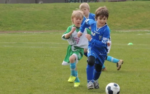 a group of kids playing football