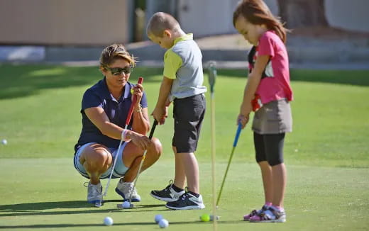 a group of kids playing golf